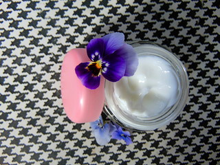Facial cream for good skin care with purple flowers