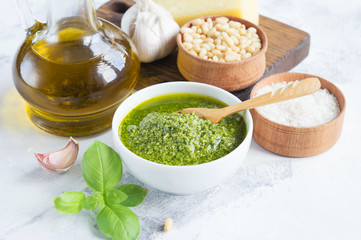 Ingredients for pesto on a white background. The finished pesto