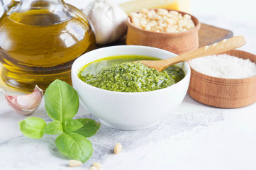 Ingredients for pesto on a white background. The finished pesto