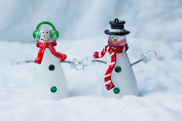 Snowmen Christmas decorations holding hands 