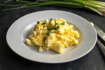 scrambled eggs on a white plate. the view from the top.