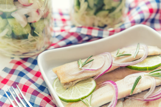Sliced herring fillets, cut onion and lime