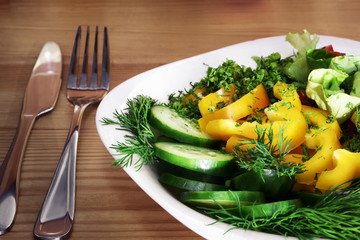 Fresh vegetable salad with sour cream sauce on the table