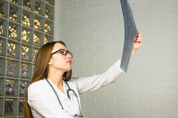 Young specialist is analysing magnetic tomography results in a clinic