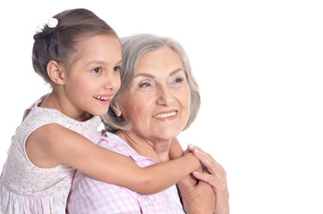 Grandmother and little granddaughter on white background