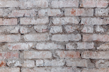 Old brick wall with white paint background texture close up