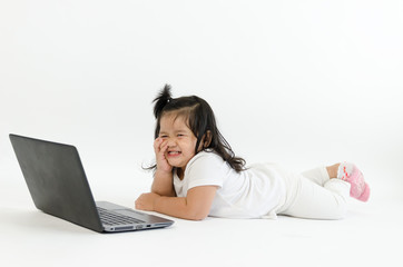 Asian child playing on computer laptop