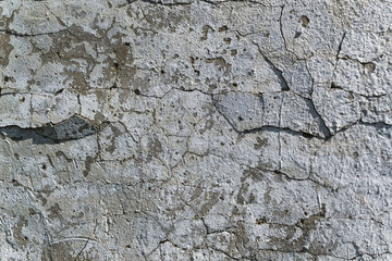 Texture of old concrete wall with cracks in the plaster