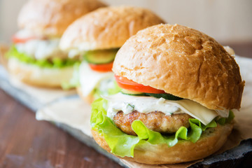 Closeup of home made burgers on wooden background