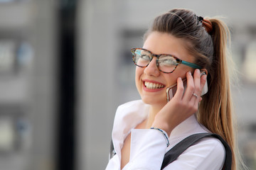 Businesswoman with a phone in a city