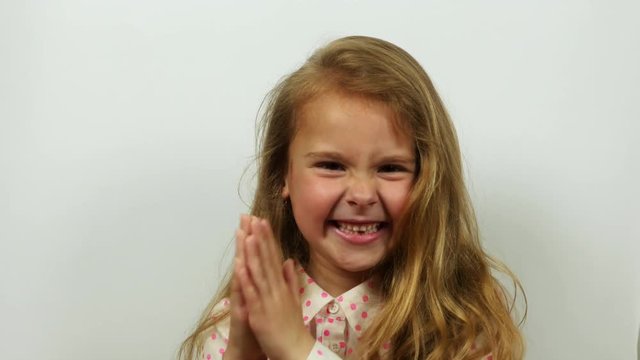 Funny girl rubs hands gloating. Smiling cute girl plotting a good idea.