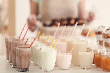 Set of different milk shakes on table