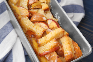 Freshly baked bread pudding in casserole dish, closeup