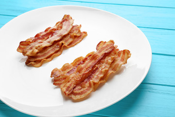 Fried bacon slices on plate