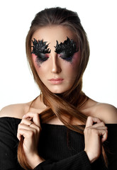 Fototapeta premium Girl close eyes with paper zigzag make-up and brown hair.Crossed hair.Creative makeup.Red background