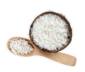 Grated coconut in shell and wooden spoon on white background