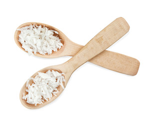 Two wooden spoons with coconut flakes on white background