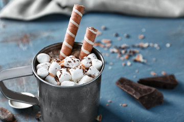 Cup of hot cocoa with marshmallows on wooden table