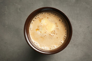 Cup of tasty butter coffee on grey table