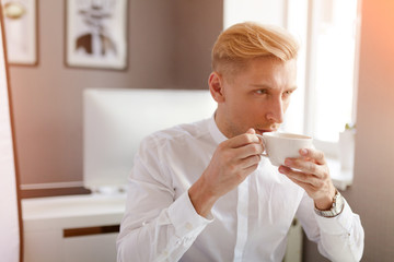 Man in office having coffee