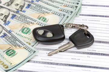 Car key and money on the documents.