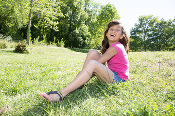 Naklejka na ściany i meble happy young girl on the grass park