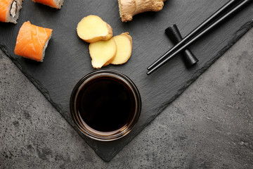 Composition with tasty soy sauce on grey textured background