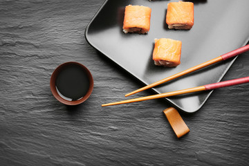 Composition with tasty soy sauce on dark textured background
