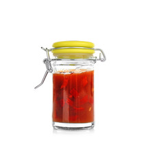 Jar with tasty chili sauce on white background