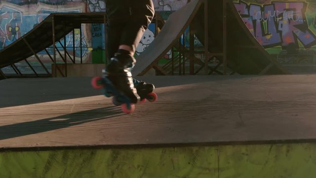 Legs of rollerblader in motion. Inline skater, ramps and graffiti. The king of concrete jungle.