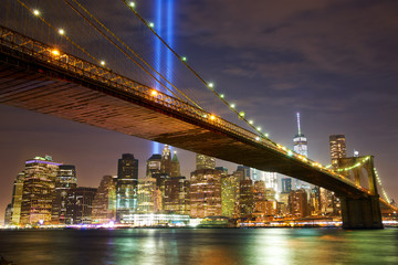 Fototapeta na wymiar Brooklyn Bridge and Manhattan skyline with light beams