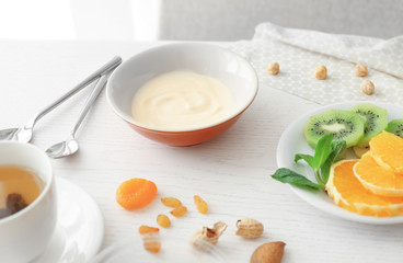 Composition with tasty yogurt on kitchen table