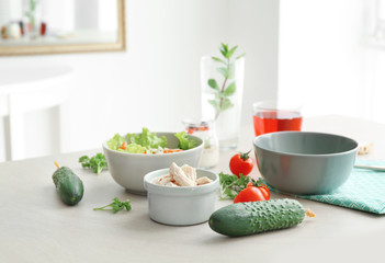 Composition with different products on kitchen table © Africa Studio