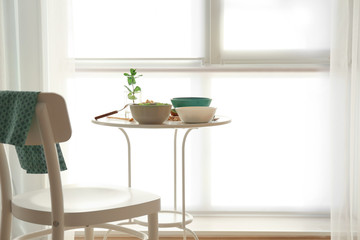 Table served for lunch near window in room