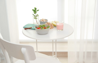 Table served for lunch near window in room