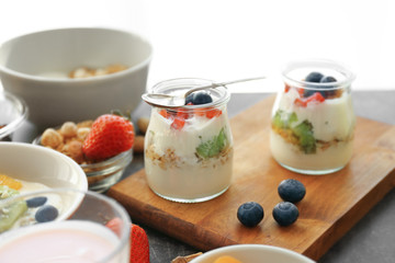 Composition with tasty yogurt and different products on table, closeup