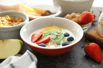Composition with tasty yogurt and different products on table, closeup