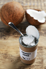 Coconut cream in tin on wooden background
