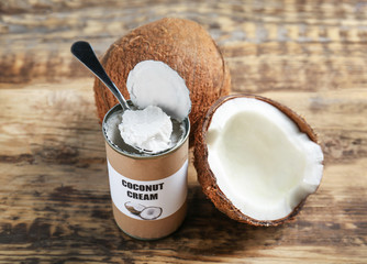 Coconut cream in tin on wooden background
