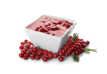 Delicious cranberry sauce in bowl on white background