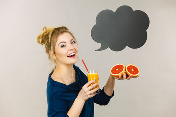 Happy woman holding fresh orange juice