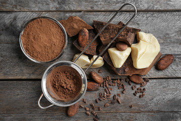 Composition of cocoa products on wooden background