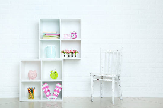 White shelves on a brick wall background