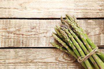 Bunch of green asparagus on grey wooden table