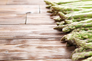 Green asparagus on brown wooden table