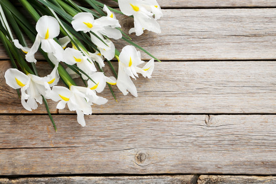 Bouquet of iris flowers on grey wooden table