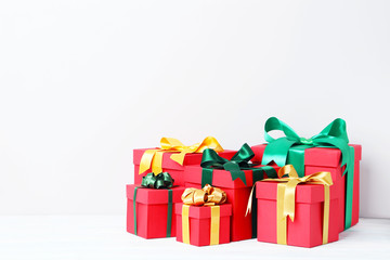 Gift boxes with ribbon on white wooden table