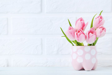 Bouquet of tulips on brick wall background