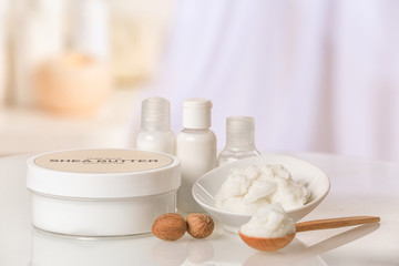 Composition of Shea butter with cosmetic products on table