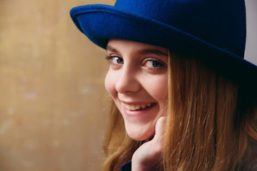 happy smiling girl in retro blue hat and blonde hair